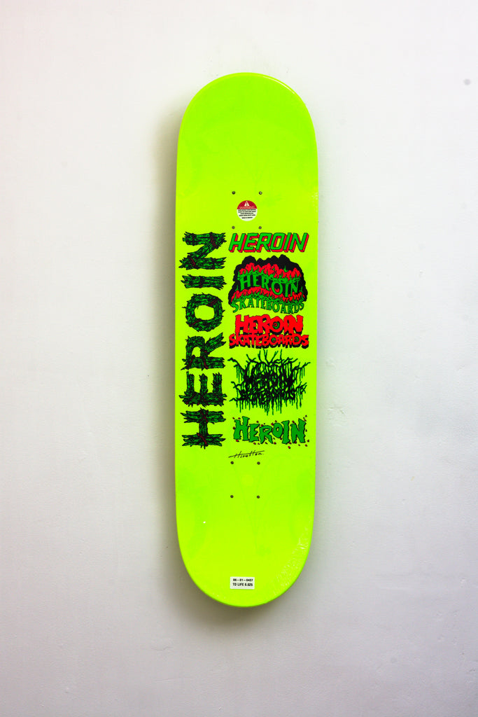 Neon green skateboard deck with black text and graphic designs.