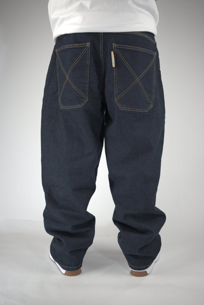 Baggy dark blue jeans with distinctive rear pocket stitching.