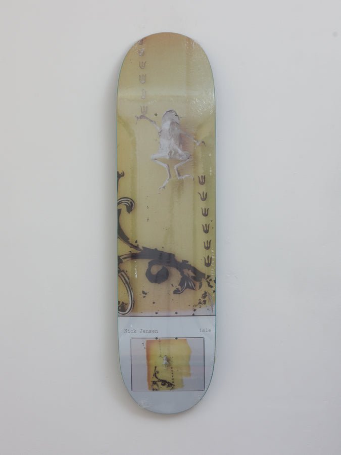 Skateboard deck featuring an artistic design with a ghostly figure and floral elements.