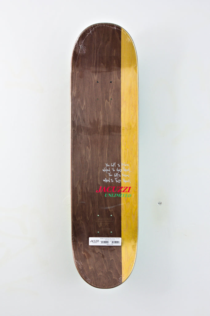 Brown skateboard deck with a yellow stripe along one edge.