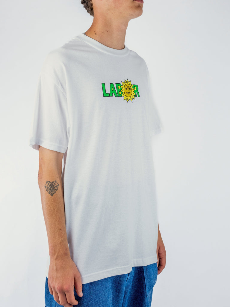 White Labor Sunflower T Shirt featuring colorful logo with smiling sun character