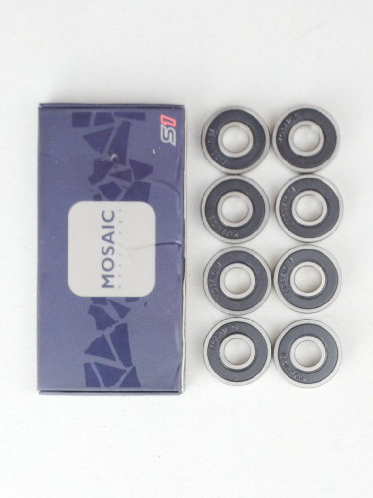 Set of skateboard or inline skate bearings with their packaging.