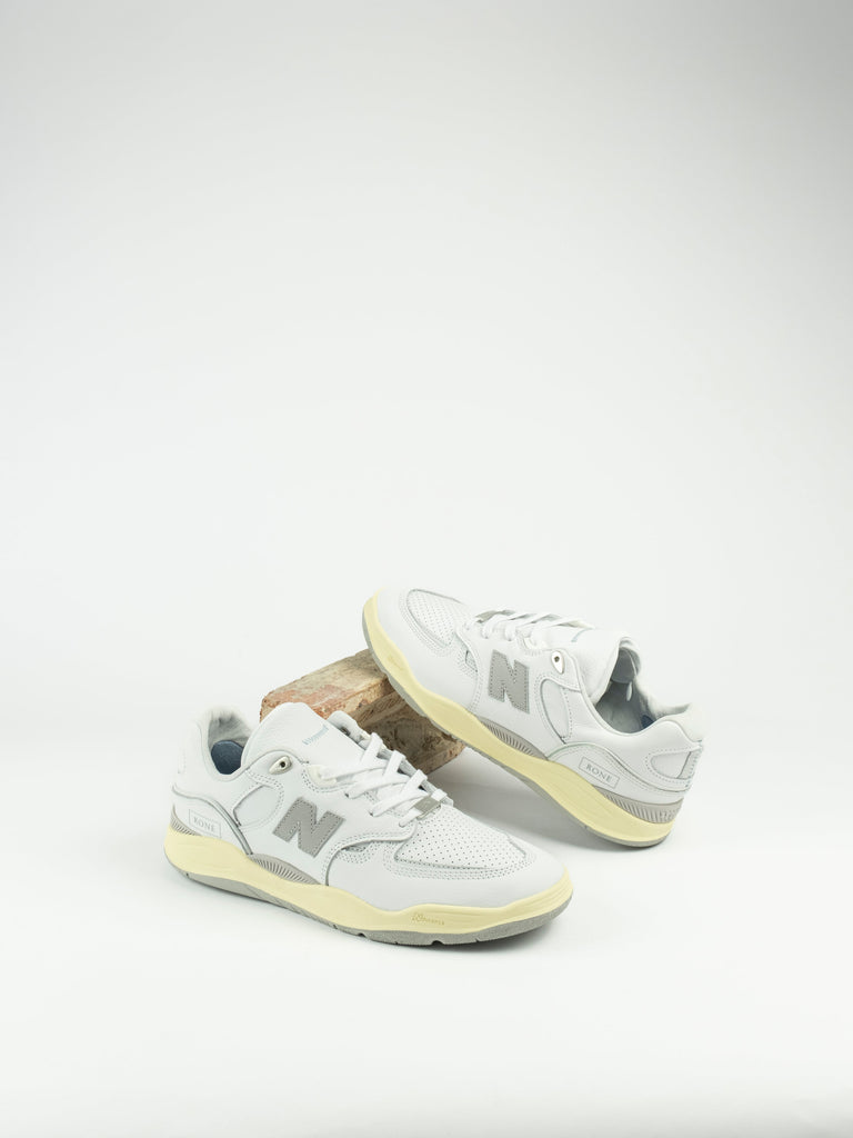 Pair of white New Balance Tiago Lemos Pro Shoes with pale yellow soles