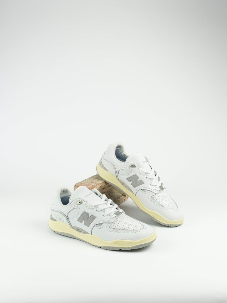 Pair of white New Balance Numeric Tiago Lemos Pro shoes with pale yellow soles