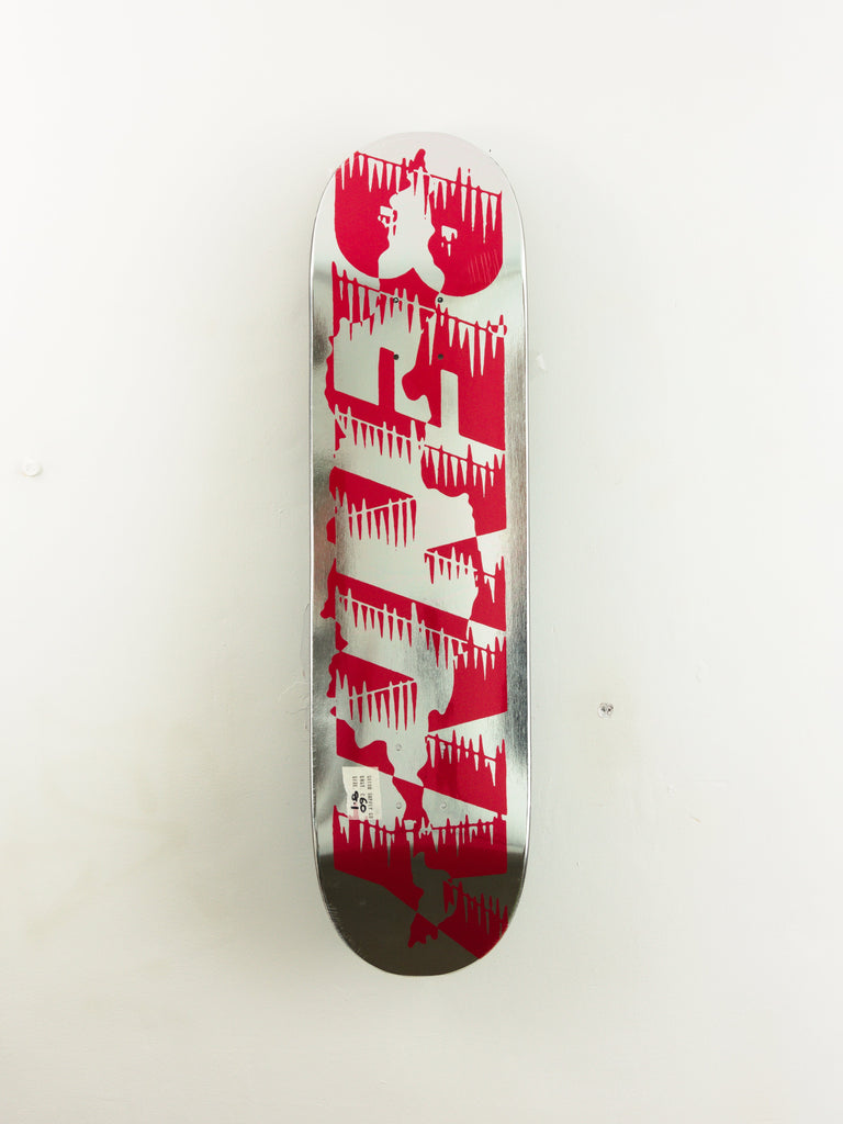 Red and white skateboard deck with a dripping paint effect design.