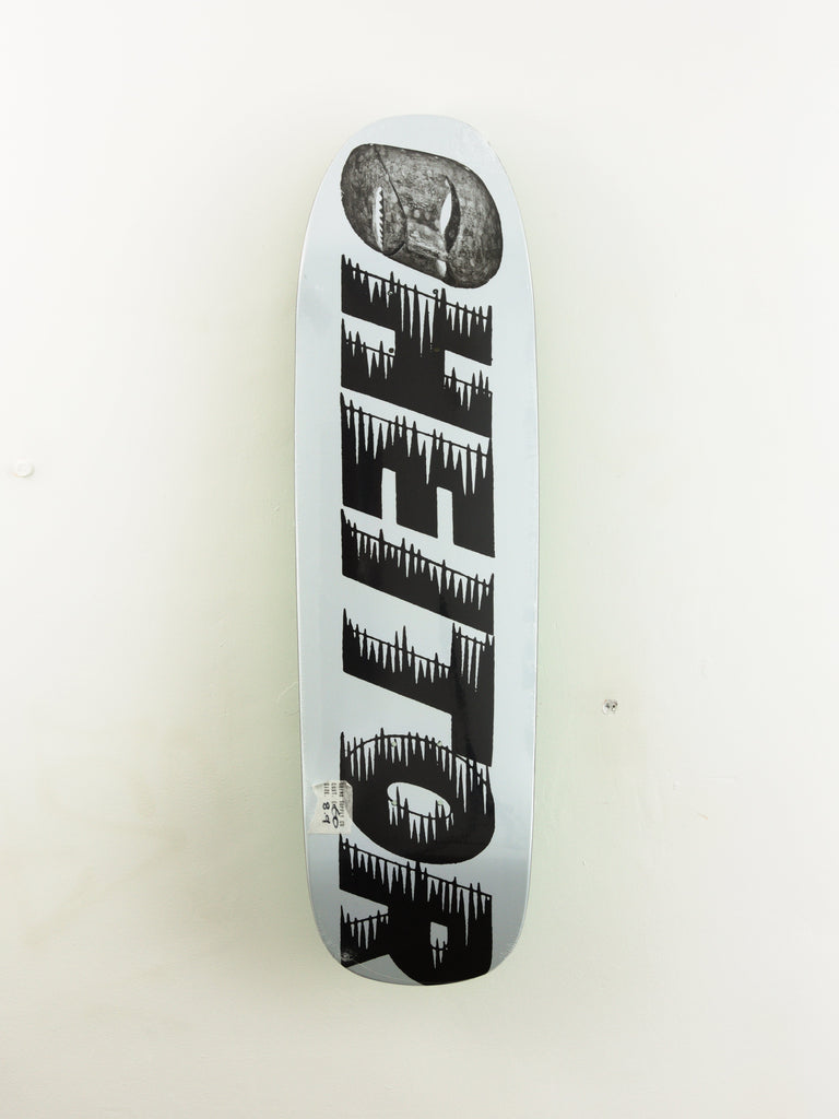 White skateboard deck with black dripping text design.