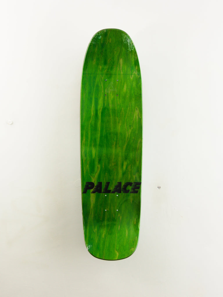 Green skateboard deck with ’PALACE’ text printed on it.