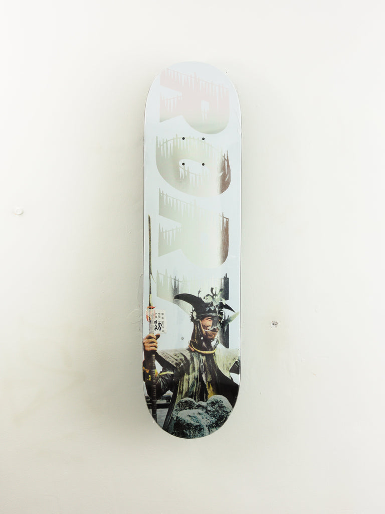 White skateboard deck with a black and white photographic design printed on its surface.