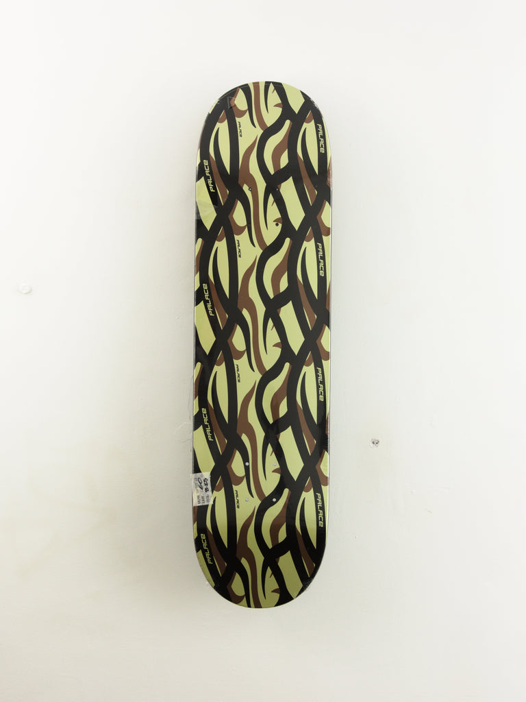 Skateboard deck with wavy brown and light green abstract pattern.