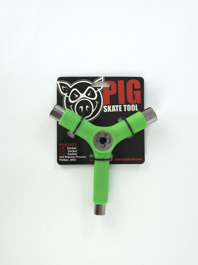 Green Y-shaped skateboard tool with metal sockets on Pig Wheels branded packaging card