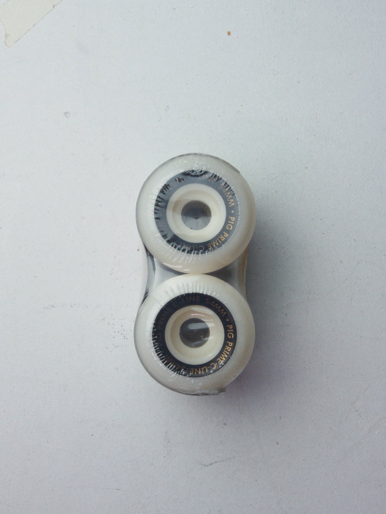 Two white skateboard wheels stacked vertically.