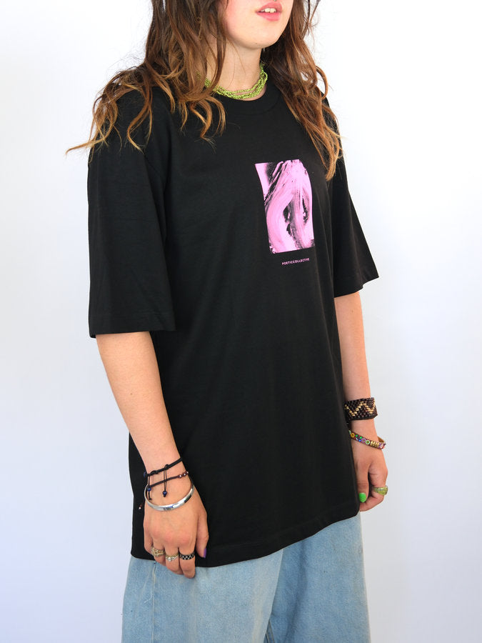 Black t-shirt with a pink graphic pocket design and neon yellow collar trim.