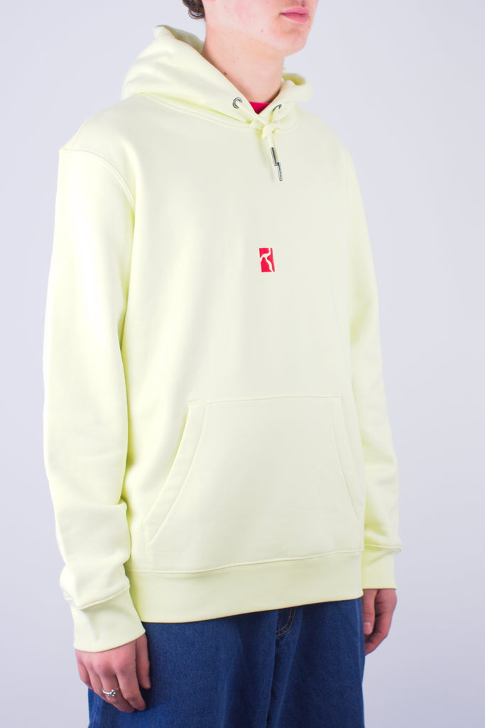 Pale yellow hooded sweatshirt with a small red logo on the chest.