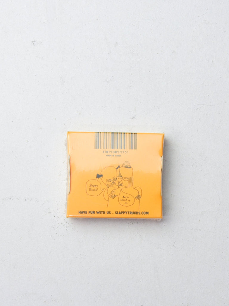 Orange-colored matchbox with simple line drawings on its surface.