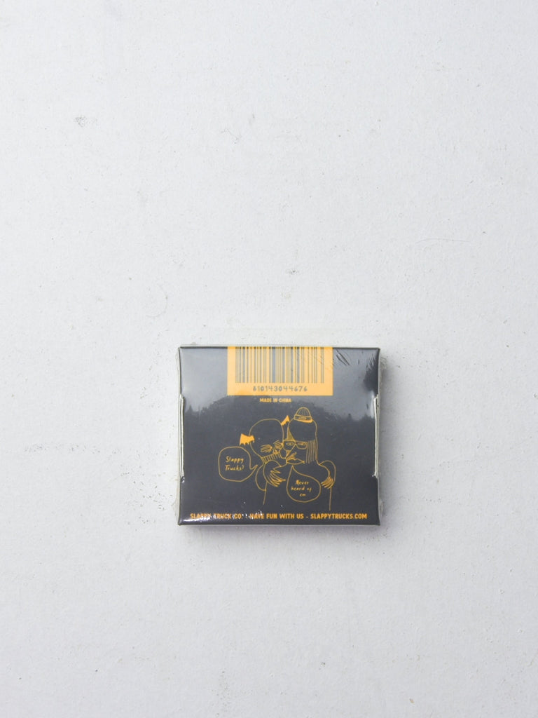 Dark-colored product box with gold line art design on it.