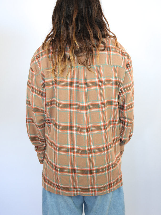 Plaid button-up shirt with a tan base color and multicolored stripes.