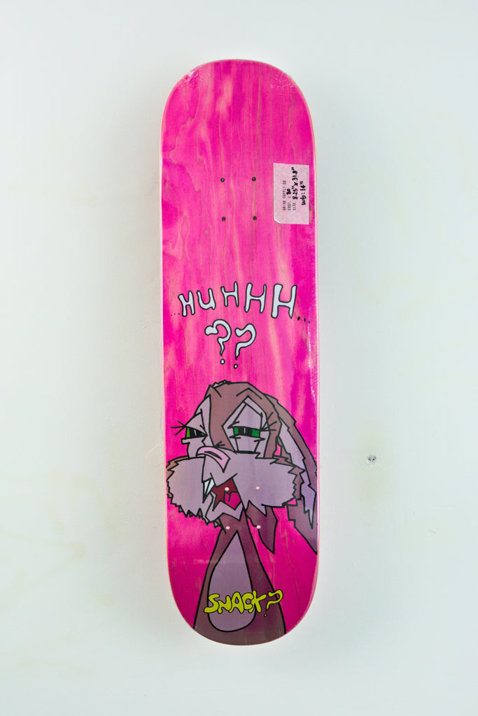 Bright pink Snack Skateboards Buns skateboard deck with cartoon character and text