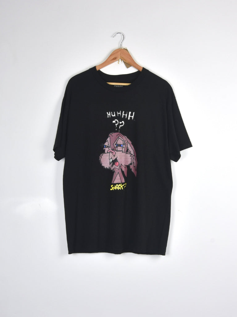 Black t-shirt with pink dinosaur graphic and text design hanging on wooden hanger.