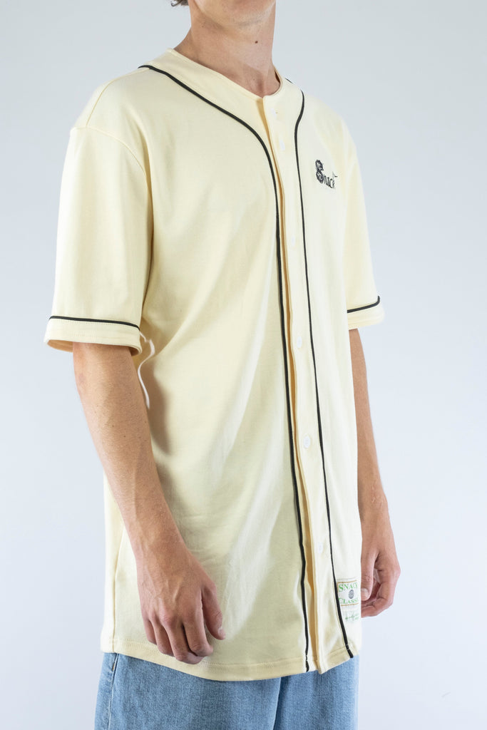 Cream-colored baseball-style jersey with black trim and a small embroidered logo.