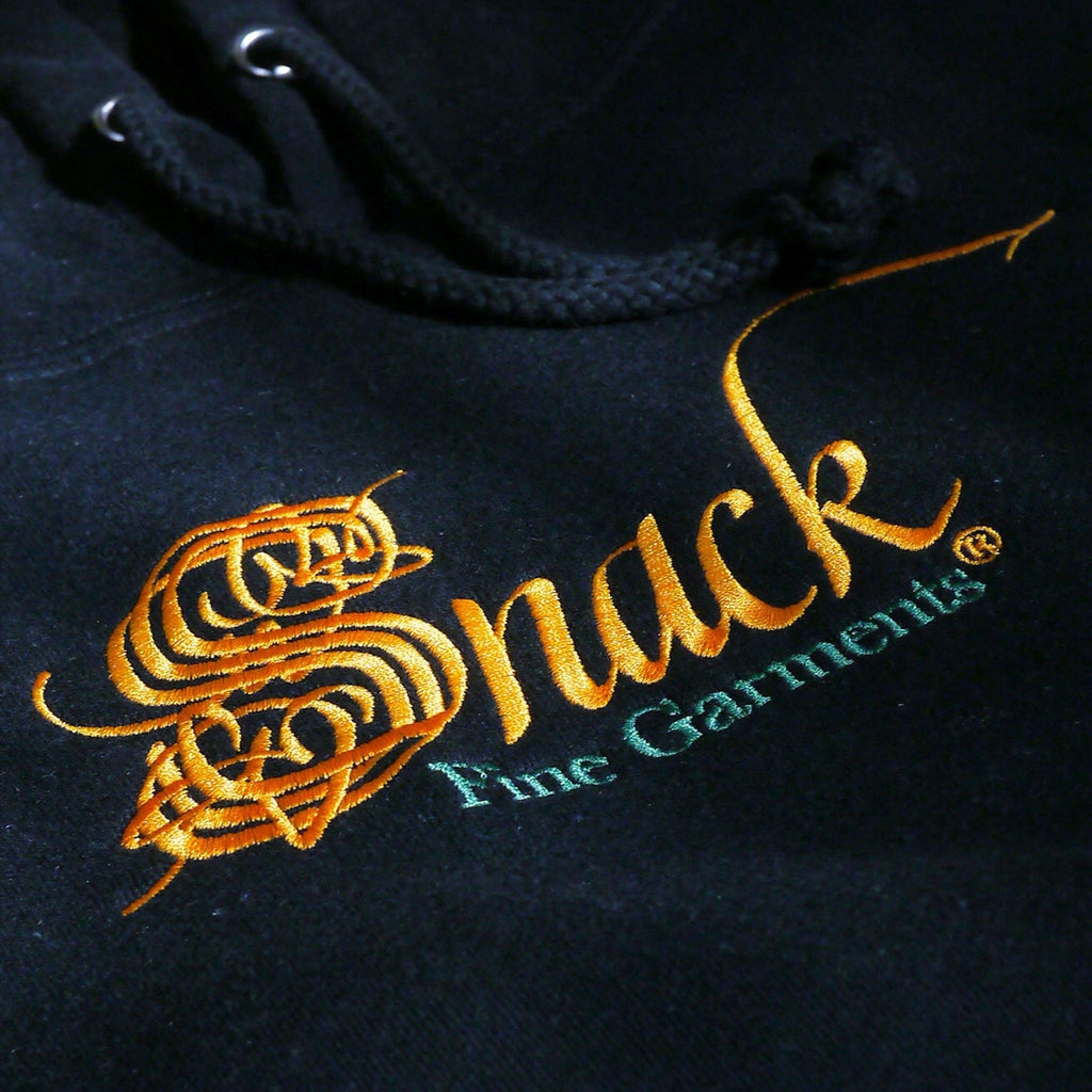 Embroidered gold and teal logo on Snack Skateboards Heavy Fleece Hooded Sweatshirt