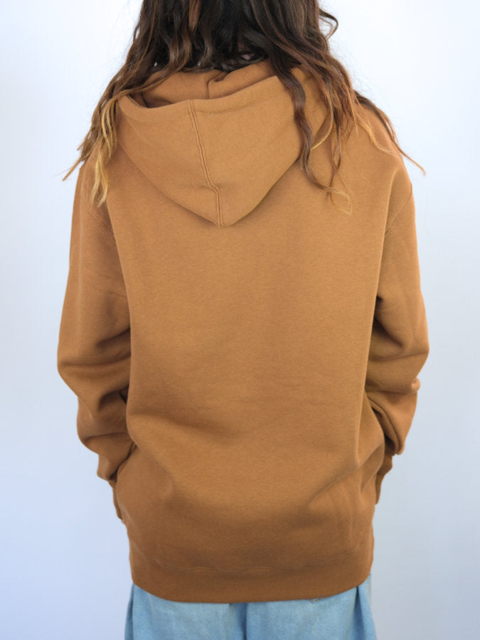 Camel-colored Terrain Hoodie in Tobacco Brown worn by a person with long wavy hair