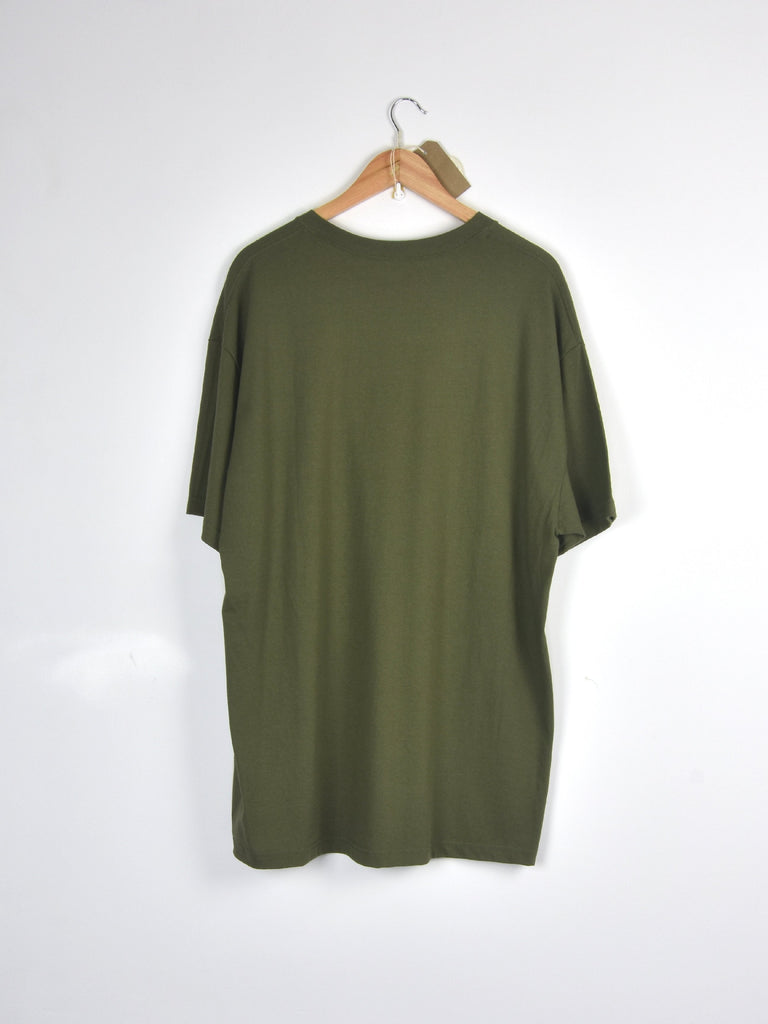 Olive green t-shirt hanging on a wooden hanger.