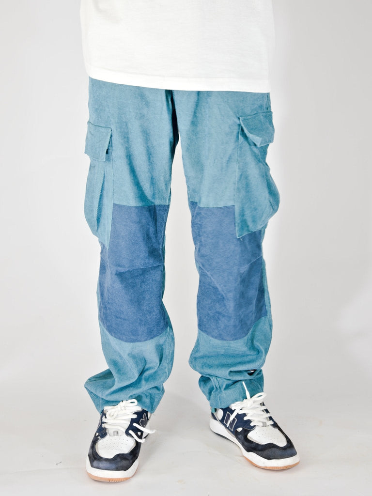 Blue Snack Skateboards Coduroy Cargo Pants with knee patches and white sneakers in baggy fit