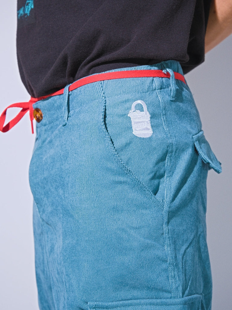 Teal Snack Skateboards coduroy cargo pants with red drawstring and white logo, baggy fit