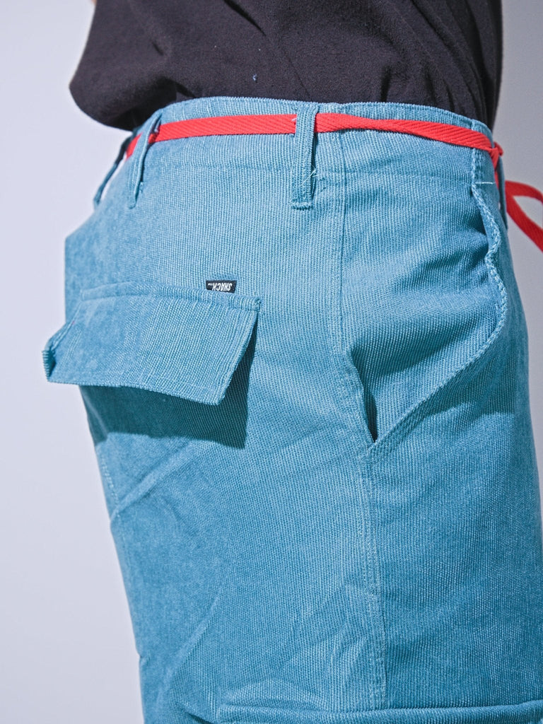 Teal Snack Skateboards coduroy cargo pants with red belt and side pocket in baggy fit