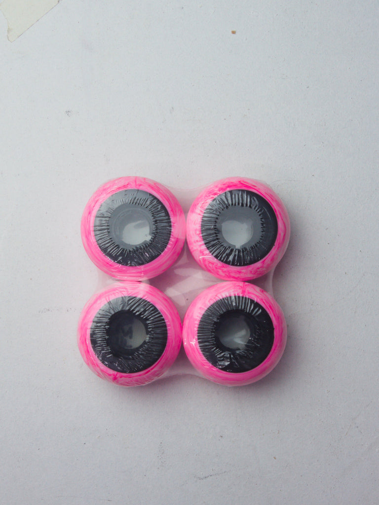 Four pink and black circular wheels arranged in a square pattern.