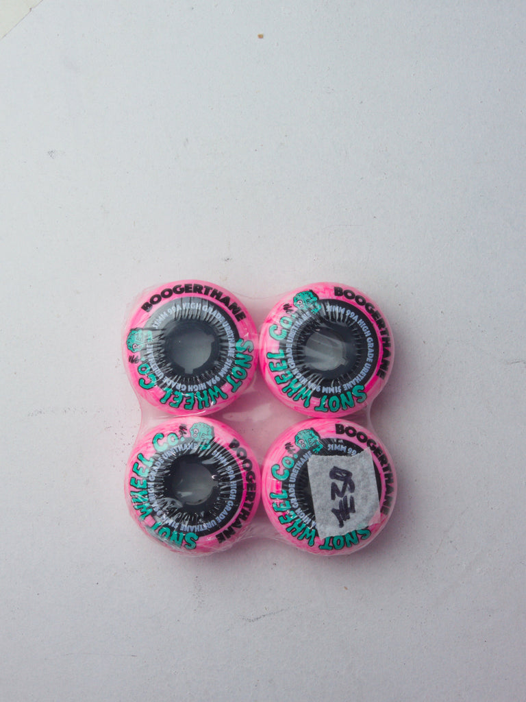 Four pink and turquoise skateboard wheels arranged in a square pattern.