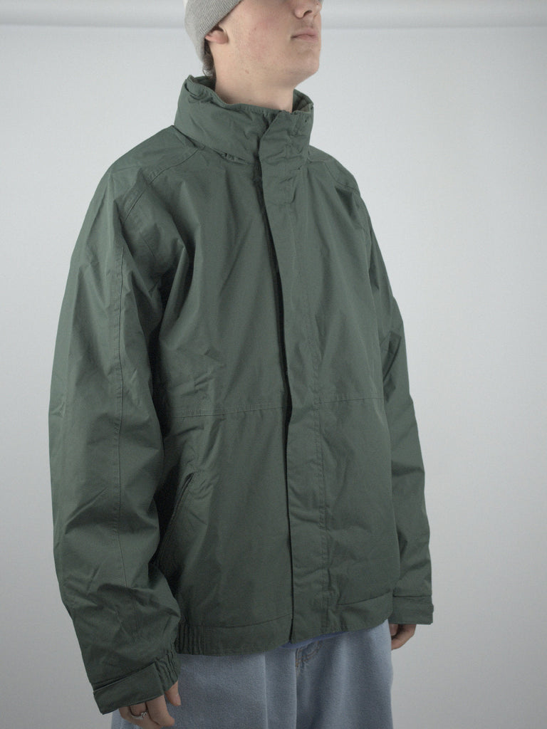 Green puffy winter jacket with high collar, a water proof fleece lined jacket in Forest Green