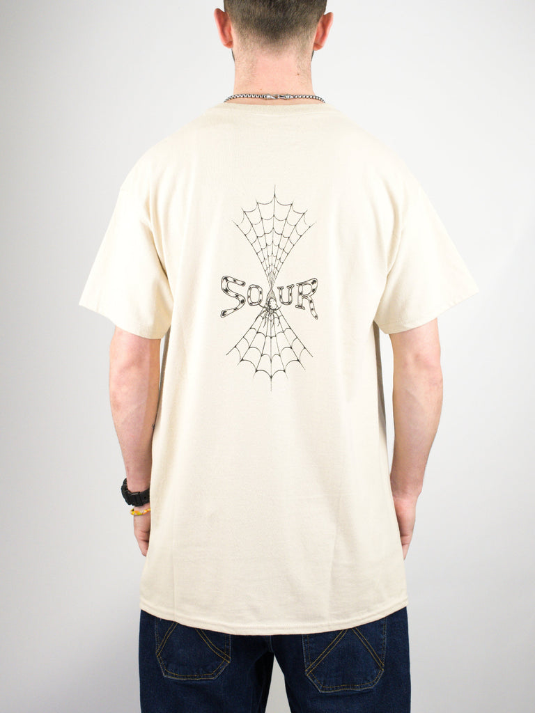 Cream-colored t-shirt with a spider web and butterfly design on the back.