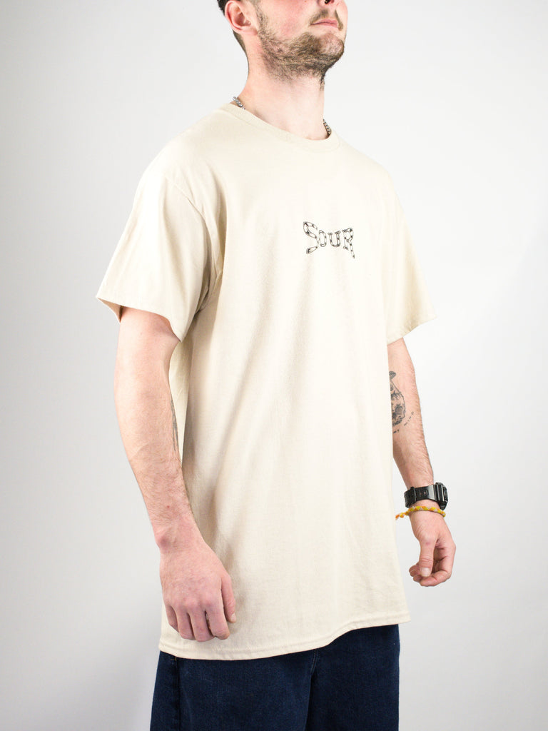 Cream-colored t-shirt with a small graphic design on the chest.