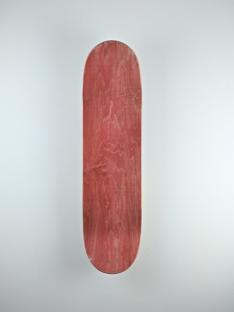 Red skateboard deck showcasing wood grain, featuring Scott Jatta Poro design