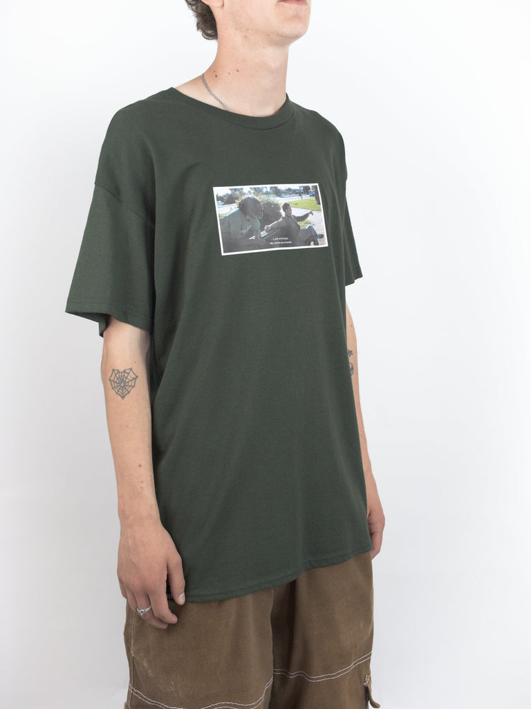 Dark green t-shirt featuring a black and white image from Sour Solution by Grind Supply Co