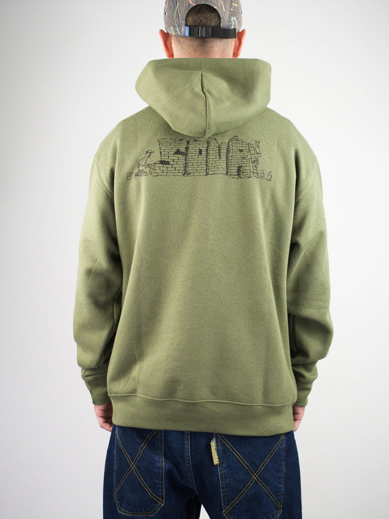 Sage green hoodie with a cityscape design printed on the back.