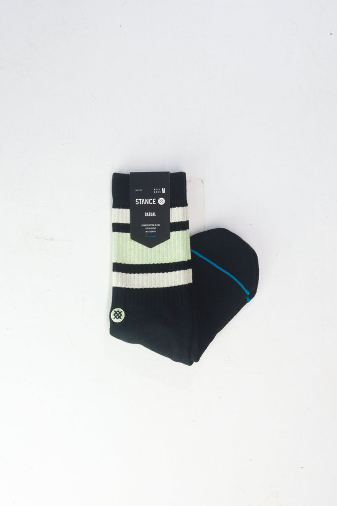 Black athletic sock with mint green stripes and a blue accent line.