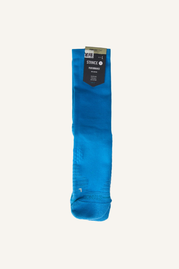Bright blue dress sock with a tag attached.