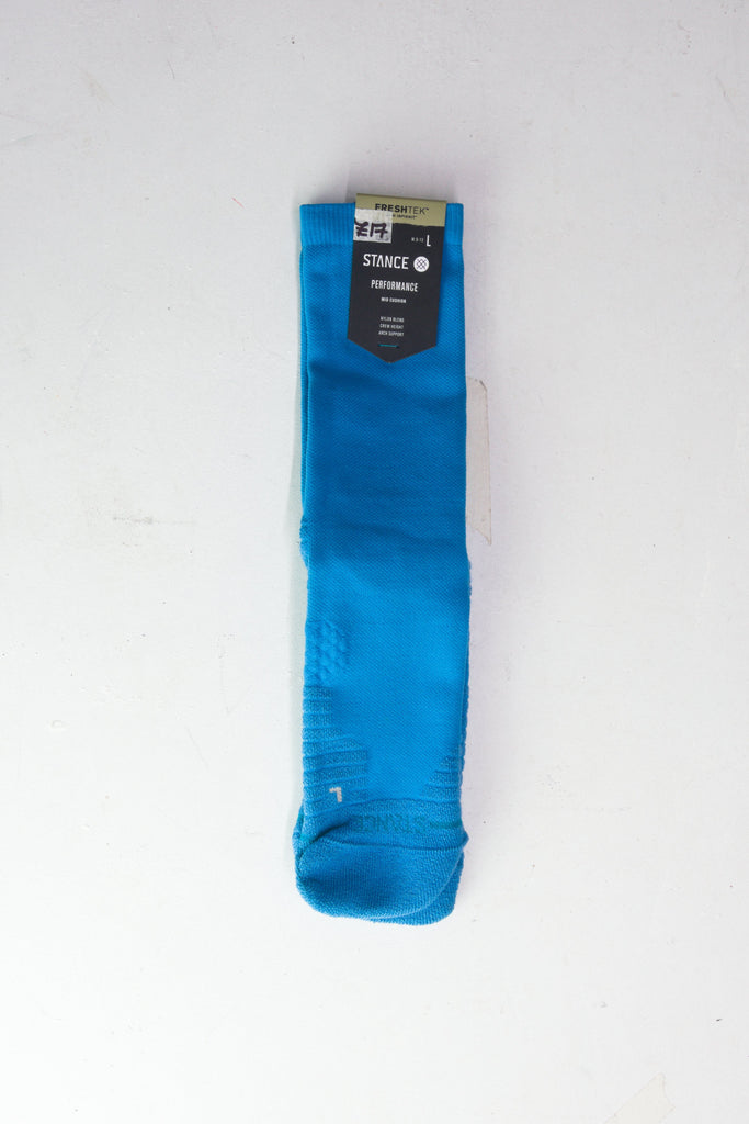 Bright blue knee-high sock with retail packaging attached.