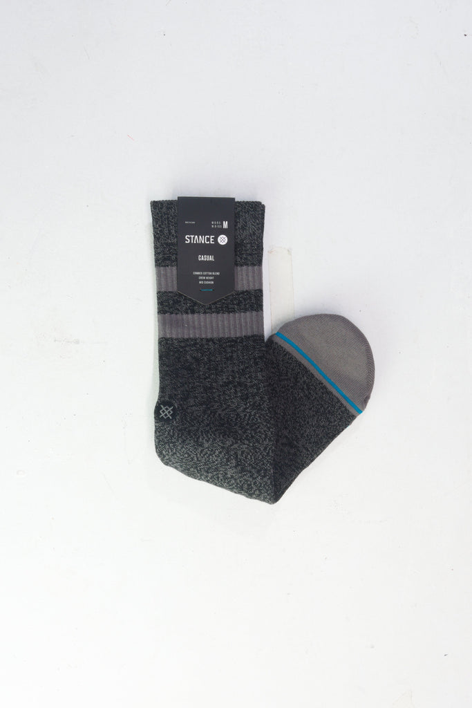 Dark gray athletic sock with striped patterns and a blue accent line.