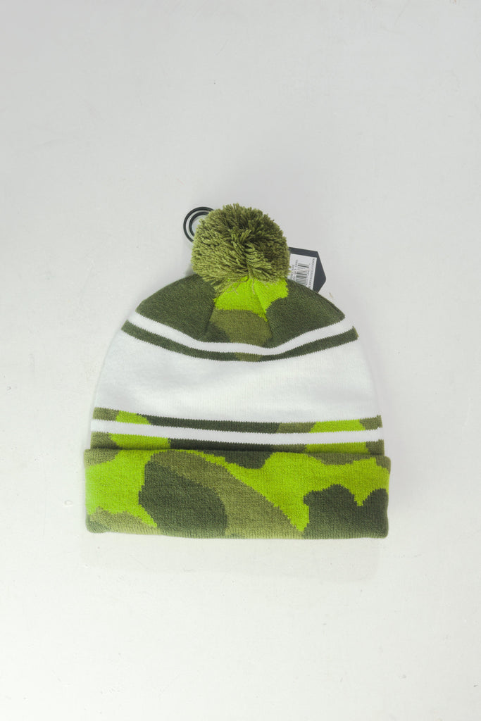 Knit winter beanie with green camouflage pattern and pom-pom.