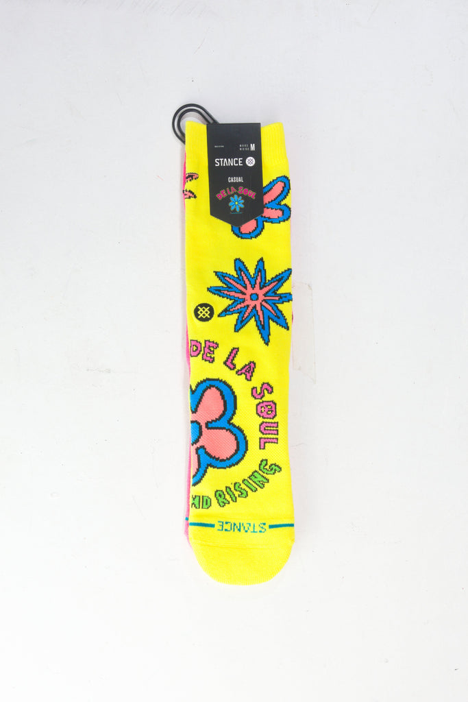 Yellow sock with colorful floral designs and text decorations.