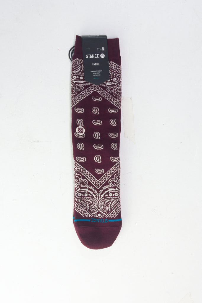 Burgundy sock with white paisley bandana-style print pattern.