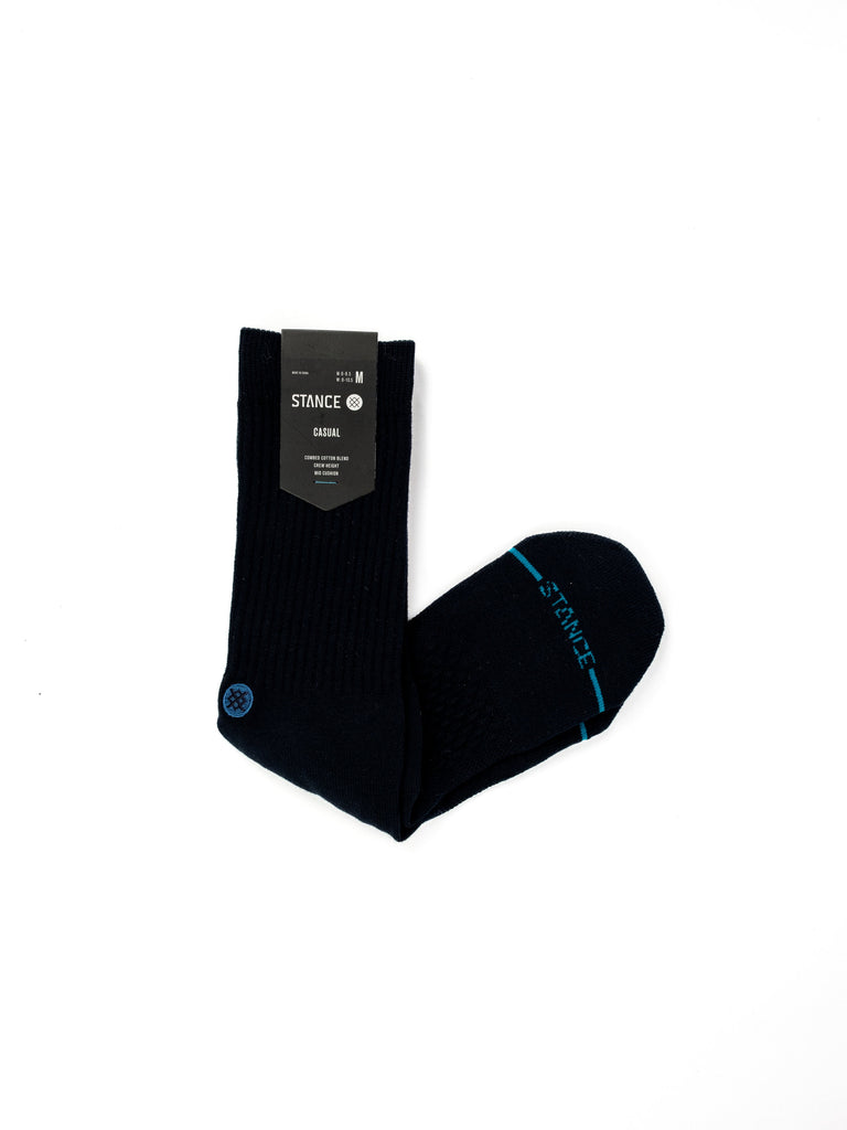 Pair of black socks with blue accents and a product tag attached.