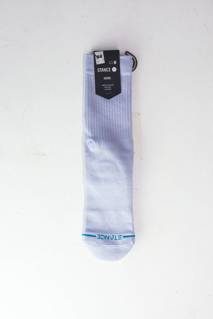 White athletic crew sock with blue accents and retail tag attached.