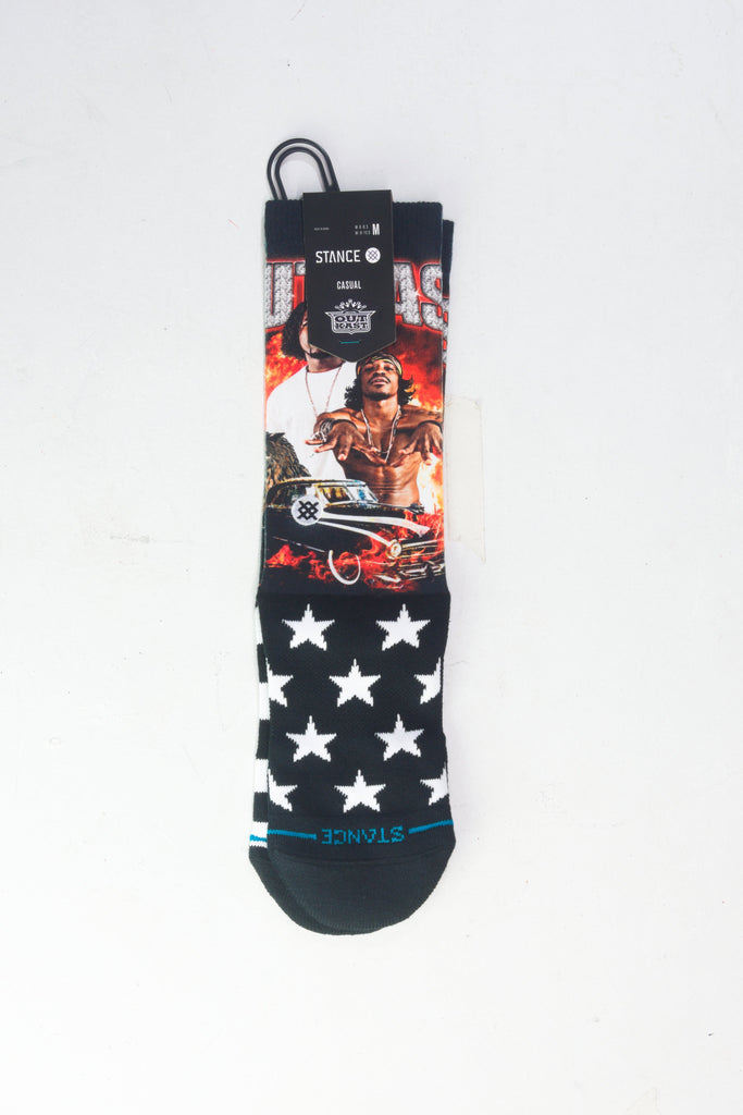 Black and red graphic sock with white stars and western-themed design.