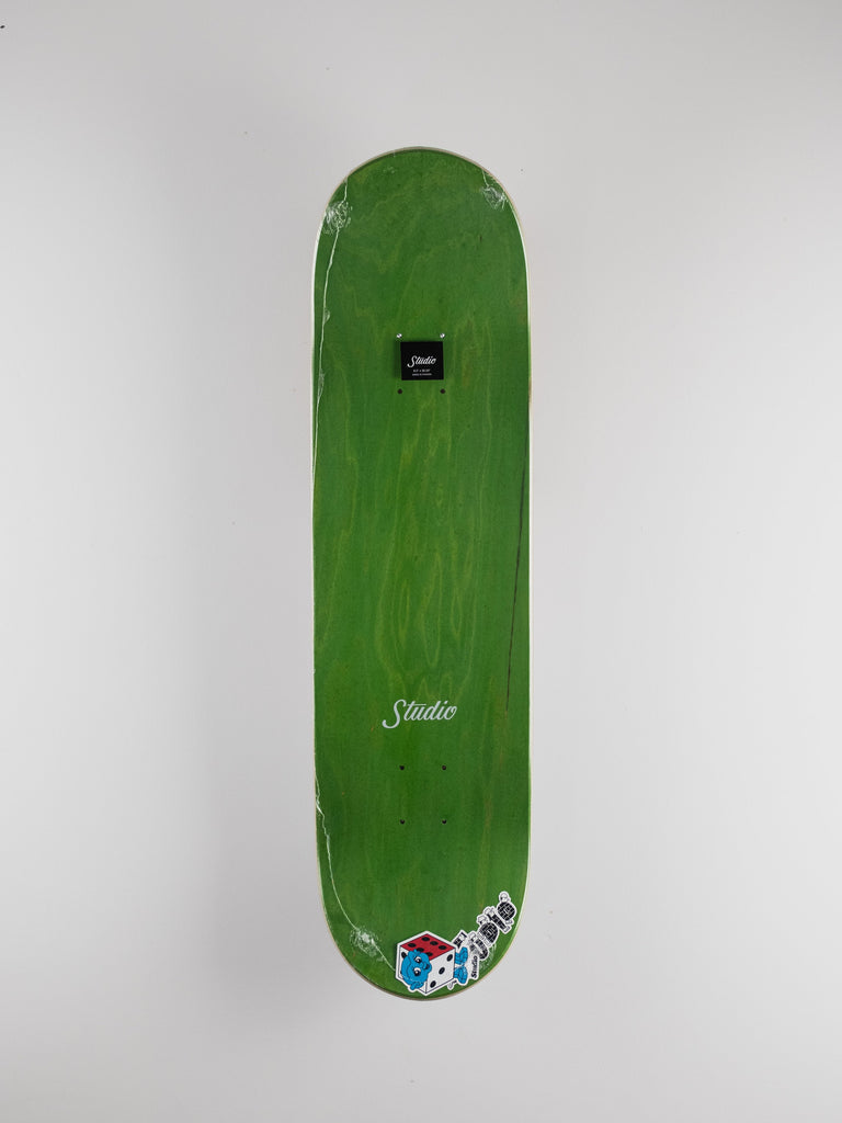 Green skateboard deck featuring Studio branding and dice graphics for Studio Skateboards