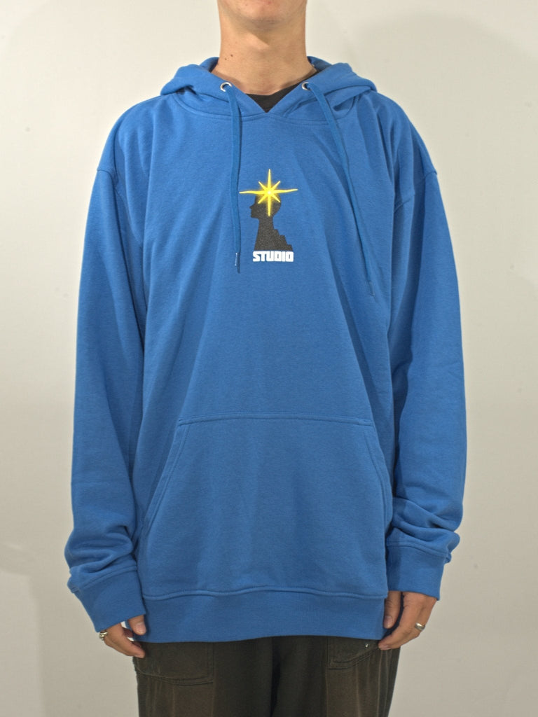 Blue hooded sweatshirt with a yellow star logo and ’STUDIO’ text on the front.
