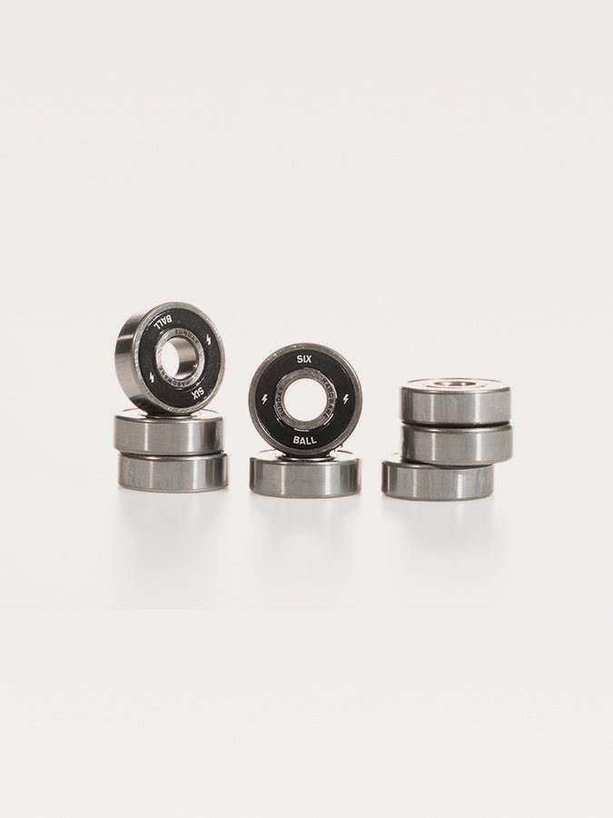 Skateboard or roller skate bearings arranged in small stacks.